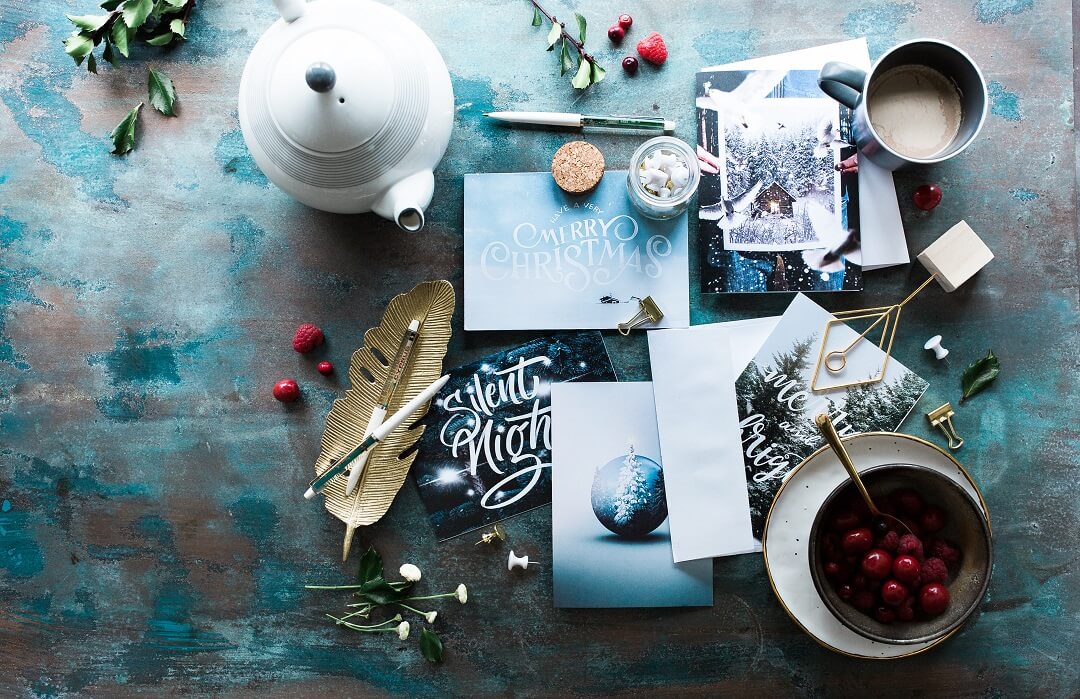 Table with Christmas cards, teapot and mug of coffee