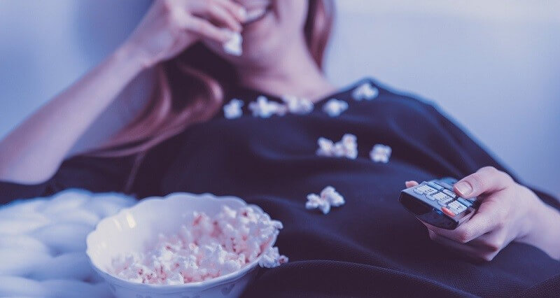 Woman watching movie with popcorn